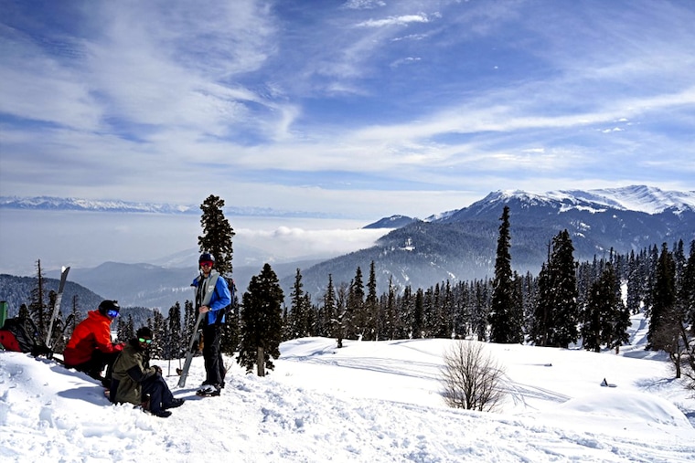 Skiers rest before heading towards a slope at a ski resort in Kangdori, Gulmarg in Srinagar on February 2, 2023. Two Polish nationals were killed and 21 other skiers were rescued after an avalanche hit a skiing resort in Gulmarg on February 1, 2023, police said.