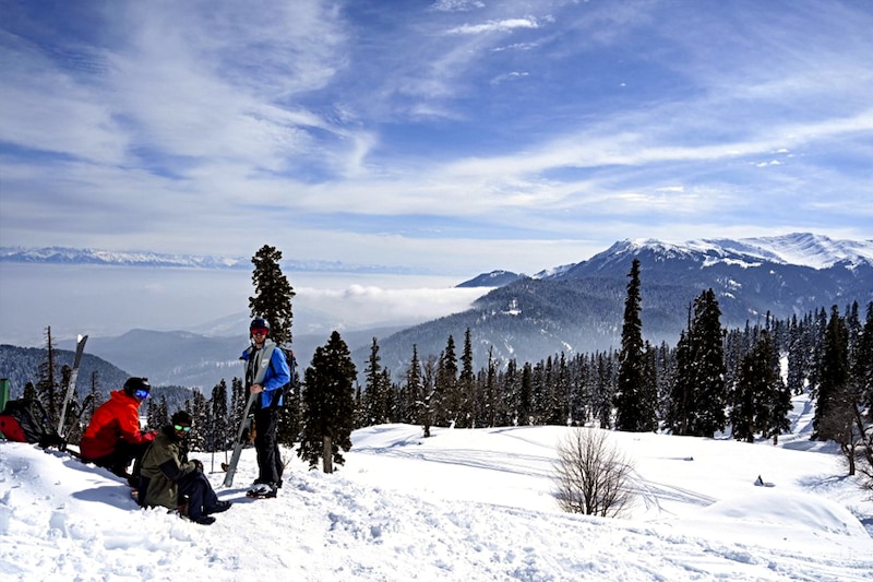 Skiers rest before heading towards a slope at a ski resort in Kangdori, Gulmarg in Srinagar on February 2, 2023. Two Polish nationals were killed and 21 other skiers were rescued after an avalanche hit a skiing resort in Gulmarg on February 1, 2023, police said.