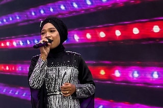 Makhi, a member of the all-female hijab-clad Nasida Ria band, performing on stage in front of an audience at a festival in Jakarta
Image: Agnes Anya / AFP