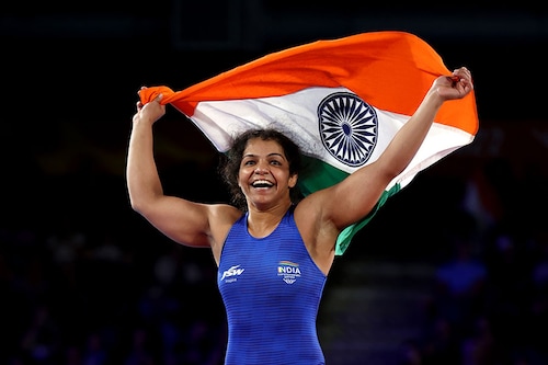 Sakshi Malik of Team India celebrates after defeating Ana Godinez Gonzalez (red) of Team Canada during the Women"s Freestyle 62 kg Gold Medal match on day eight of the Birmingham 2022 Commonwealth Games at  on August 05, 2022 on the Coventry, England. Image Credit: Al Bello/Getty Images