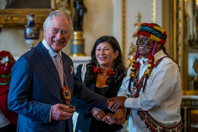 Amazon Indigenous leader Domingo Peas (R) present gifts to Britain"s King Charles III during a reception in support of action on global biodiversity at Buckingham Palace on February 17, 2023 in London, England. The reception provided an opportunity to discuss the practical delivery of the Global Biodiversity Framework.