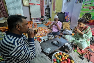 Artist Avaz Mohammad, with his family members, prepares the traditional "Gulaal Gota" colour balls which are made of lac and dry hygienic eco-friendly colour "Abeer or Gulaal" ahead of the Holi Festival, in Jaipur, Rajasthan, India on Wednesday, February 22, 2023.