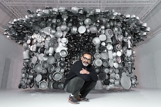 Indian artist Subodh Gupta poses in front of one of his installations.
Image: Joel Saget / AFP