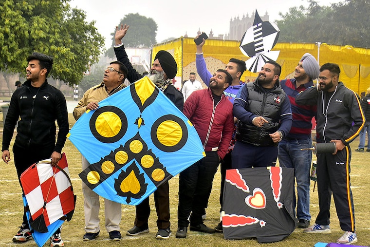 People gathered to fly kites during a kite flying competition on the eve of the Lohri festival at Khalsa College on January 12, 2023, in Amritsar, India.