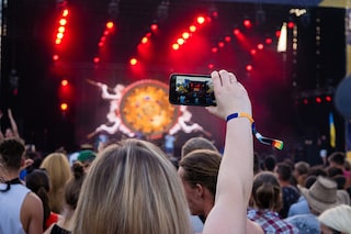 Not a single concert or music festival goes by without the artist on stage having to perform to a cloud of smartphones raised to film or photograph them.
Image: Shutterstock