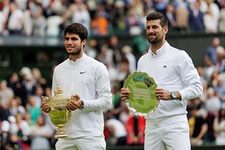 Carlos Alcaraz of Spain and Novak Djokovic of Serbia pose with their trophies after the final of the men"s singles during day fourteen of The Championships Wimbledon 2023 at All England Lawn Tennis and Croquet Club on July 16, 2023 in London, England.