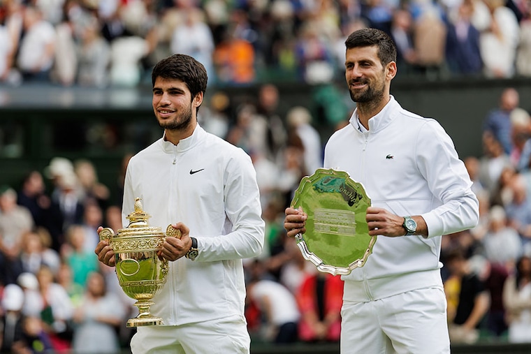Carlos Alcaraz of Spain and Novak Djokovic of Serbia pose with their trophies after the final of the men"s singles during day fourteen of The Championships Wimbledon 2023 at All England Lawn Tennis and Croquet Club on July 16, 2023 in London, England.