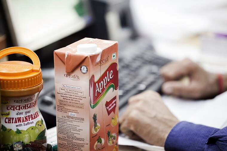 (File photo) A container of chyawanprash and a carton of apple juice sit on a counter at a Patanjali Ayurved Ltd. store in New Delhi, India on Saturday, November 19, 2016. Image: Udit Kulshrestha/Bloomberg