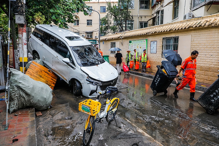 Cars blown over after Super Typhoon Doksuri torrential rain in a community in Jinan, East China"s Shandong Province, July 29, 2023.