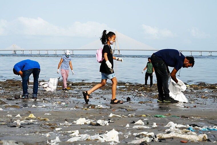 Volunteers take part in a beach cleaning drive ahead of the World Environment Day in Mumbai on June 4, 2023.