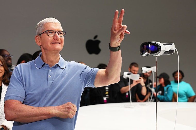 Apple CEO Tim Cook stands next to the new Apple Vision Pro headset displayed during the Apple Worldwide Developers Conference on June 05, 2023, in Cupertino, California. Cook kicked off the annual WWDC23 developer conference with the announcement of the new Apple Vision Pro mixed reality headset.