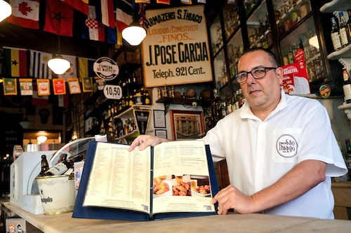 Carlos Fionda, 59, manager of Amazem Sao Thiago bar, shows their physical menu at the Lapa neighborhood in Rio de Janeiro.
Image: Mauro Pimentel / AFP