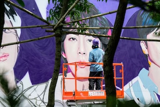 An artist spray paints a mural of K-pop megastars BTS in Seoul on June 12, 2023, on the occasion of the supergroup"s 10-year anniversary.
Image: Anthony Wallace / AFP