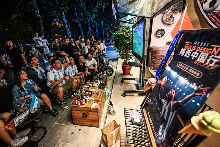 Football fans wearing Argentina"s team jersey watch the television live stream of a friendly match between Australia and Argentina in Beijing on June 15, 2023.