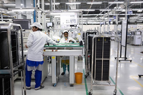 Employees work on an assembly line in the mobile phone plant of Rising Stars Mobile India Pvt., a unit of Foxconn Technology Co. in Sriperumbudur, Tamil Nadu, India Image: Karen Dias/Bloomberg via Getty Images