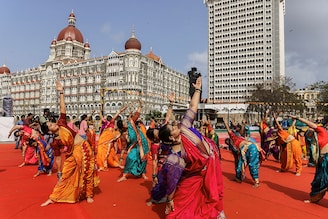 People perform yoga in front of the Taj Hotel during International Yoga Day in Mumbai, India, June 21, 2023.