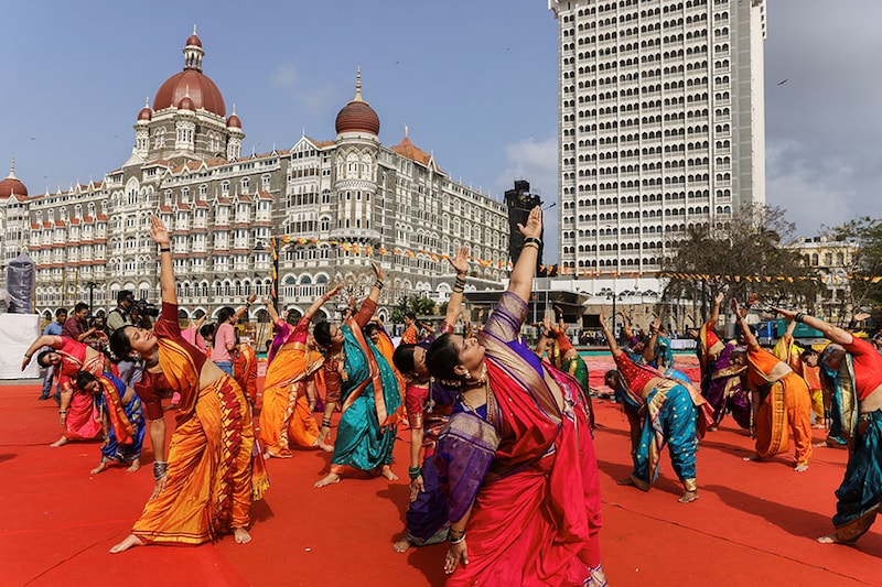 People perform yoga in front of the Taj Hotel during International Yoga Day in Mumbai, India, June 21, 2023.