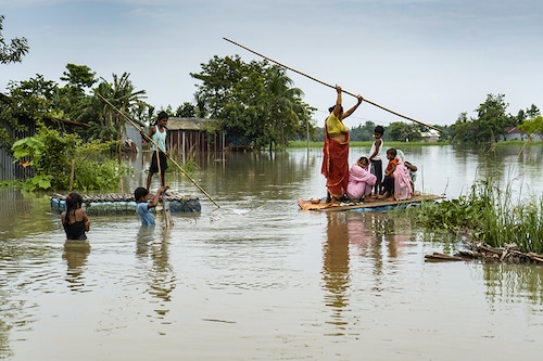 Villagers cross a flooded area on a raft in Barpeta in Assam, India on June 23, 2023. Over 500 thousand people have been severely affected in 22 districts of Assam.