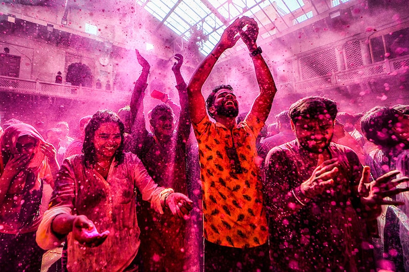 Devotees pray at Radha Ballav Temple during the Holi festival with colourful powders (Gulal). Radha Ballav Temple is one of the oldest and most auspicious temples, where Lord Krishna is worshipped during the Holi festival.