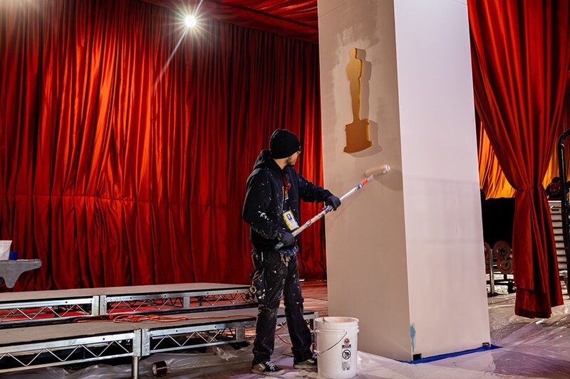 Crews work on finishing up the details of the arrivals area, for the 95th Academy Awards, outside the Dolby Theatre on Hollywood Boulevard in Los Angeles, California on Thursday, March 9, 2023.