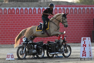 An Indian army soldier performs a stunt during the western command investiture ceremony at a military station on the outskirts of Amritsar on March 10, 2023.