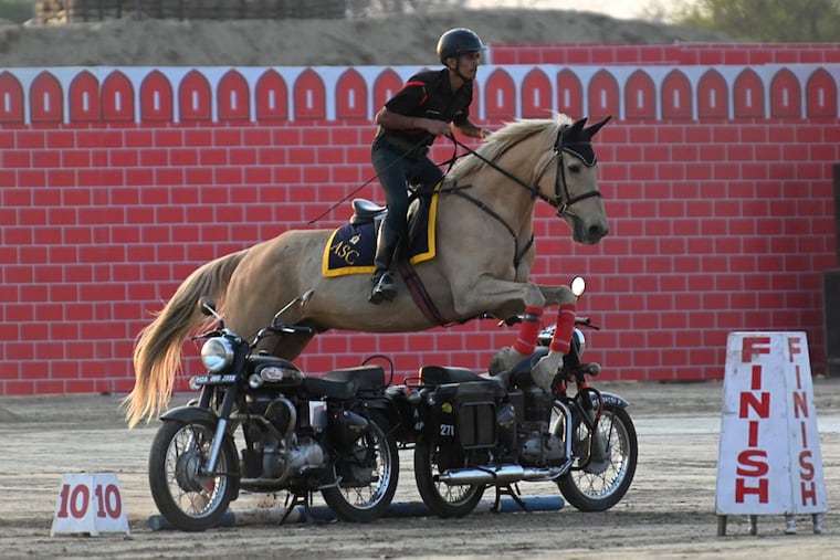 An Indian army soldier performs a stunt during the western command investiture ceremony at a military station on the outskirts of Amritsar on March 10, 2023.