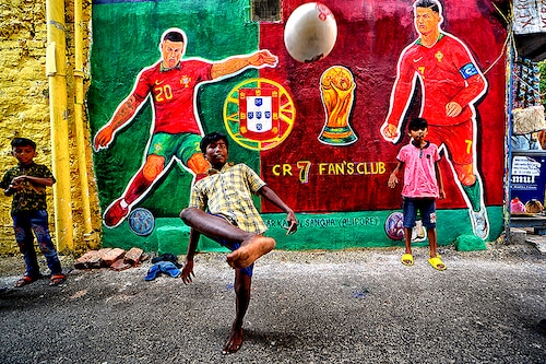 Children seen playing football in front of a graffiti wall with Cristiano Ronaldo (7) along the street as they celebrate FIFA World Cup 2022 in Kolkata.
Image: Avishek Das/SOPA Images/LightRocket via Getty Images Children seen playing football in front of a graffiti wall with Cristiano Ronaldo (7) along the street as they celebrate FIFA World Cup 2022 in Kolkata.
Image: Avishek Das/SOPA Images/LightRocket via Getty Images