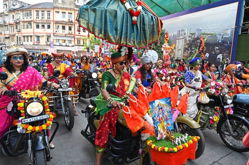 Women dressed in traditional attire ride motorcycles during a procession to mark "Gudi Padwa" or the Maharashtrian New Year, in Mumbai on March 22, 2023.