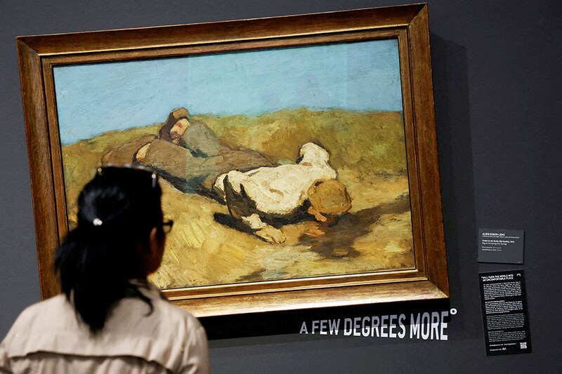 A visitor of the Leopold museum looks at the painting " A boy at the spring " by Albin Egger Lienz after the museum tilted 15 of its paintings in protest of climate change in Vienna, Austria, March 22, 2023.
