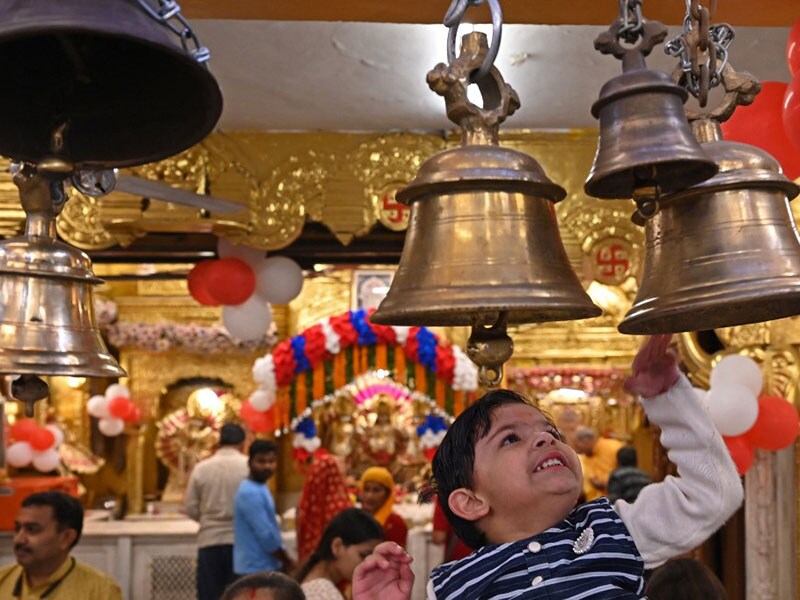 A child rings a bell during prayers on the occasion of Rama Navami festival, marking the birth anniversary of Lord Rama at a temple in New Delhi on March 30, 2023.