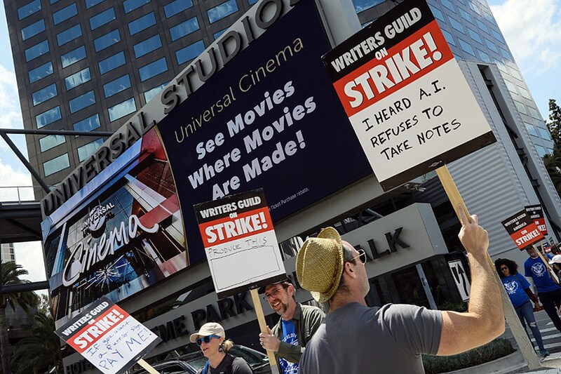 Members of the Writers Guild of America (WGA) and its supporters picket outside of Universal Studios on May 3, 2023, in Universal City, California. Writers Guild of America members have gone on strike in a contract dispute with studios and streaming services over lowering wages, residuals and the future of AI in entertainment.
