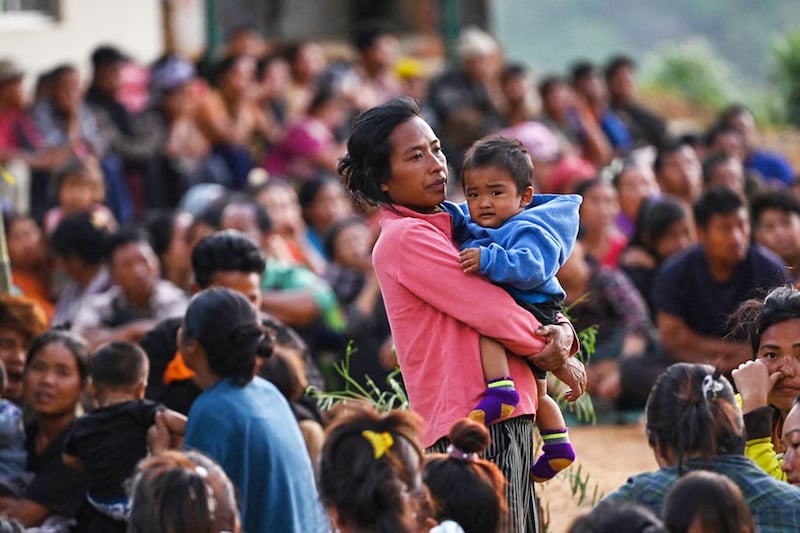 People wait at a temporary shelter in a military camp, after being evacuated by the Indian army, as they flee ethnic violence that has hit the northeastern State of Manipur on May 7, 2023. Some 23,000 people have fled ethnic violence in northeast India that has reportedly killed at least 54, the army said on May 7, 2023, although there was no new "major violence" overnight.