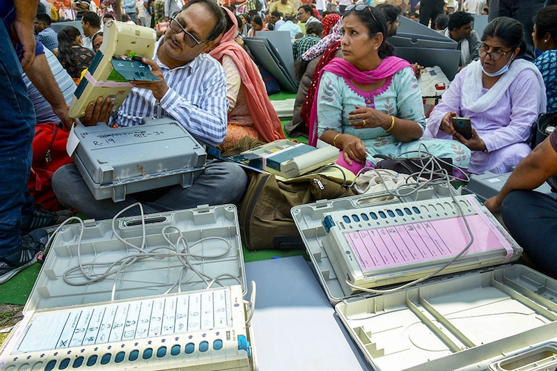Polling officials are seen collecting Electronic Voting Machines (EVMs) and other election materials for the second phase of the Municipal election at a distribution center in Kamla Nehru Nagar on May 10, 2023, in Ghaziabad, Uttar Pradesh, India.
