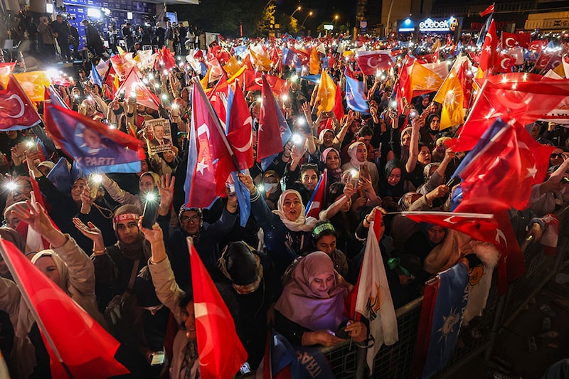 Supporters of Turkish President Tayyip Erdogan wave flags outside the AK Party headquarters after polls closed in Turkey"s presidential and parliamentary elections in Ankara, Turkey May 15, 2023. Turkey is braced for its first election runoff after a night of high drama showed President Recep Tayyip Erdogan edging ahead of his secular rival but failing to secure a first-round win.