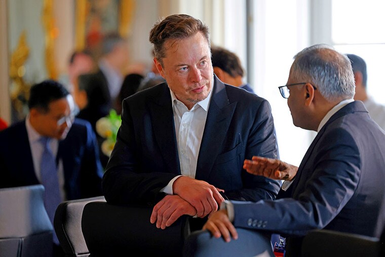 Electric car maker Tesla CEO Elon Musk talks to Chairman of Tata Sons Natarajan Chandrasekaran before a roundtable during the 6th edition of the "Choose France" Summit at the Chateau de Versailles, outside Paris on May 15, 2023. Since 2018, the Choose France Summit seeks to promote France"s economic attractiveness and encourage international investment across the country and brings together hundreds of leaders from the largest multinational corporations.