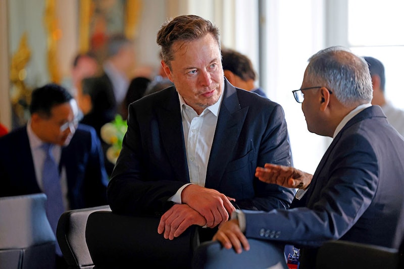 Electric car maker Tesla CEO Elon Musk talks to Chairman of Tata Sons Natarajan Chandrasekaran before a roundtable during the 6th edition of the "Choose France" Summit at the Chateau de Versailles, outside Paris on May 15, 2023. Since 2018, the Choose France Summit seeks to promote France"s economic attractiveness and encourage international investment across the country and brings together hundreds of leaders from the largest multinational corporations.