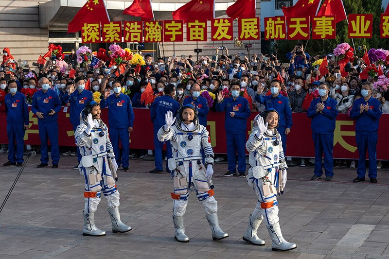 China"s first civilian astronaut Gui Haichao (left) along with fellow astronauts Zhu Yangzhu and Jing Haipeng from China"s Manned Space Agency wave to wellwishers at a pre-launch departure ceremony of Shenzhou-16 spacecraft on May 30, 2023, in Jiuquan, China. The three astronaut crew will be carried to China"s new orbiting Tiangong Space Station and replace a similar crew that has been there for the last six months.