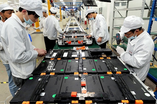 Workers at a factory for Xinwangda Electric Vehicle Battery Co. Ltd, which makes lithium batteries for electric cars and other uses, in Nanjing in China"s eastern Jiangsu province 
Image: STR / AFP