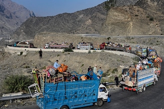 Trucks transporting Afghan refugees with their belongings are seen along a road towards the Pakistan-Afghanistan Torkham border on November 3, 2023, following Pakistan"s government decision to expel people illegally staying in the country. More than 165,000 Afghans have fled Pakistan since Islamabad issued an ultimatum to 1.7 million people a month ago to leave or face arrest and deportation, officials said on November 2.