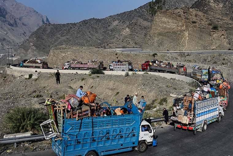 Trucks transporting Afghan refugees with their belongings are seen along a road towards the Pakistan-Afghanistan Torkham border on November 3, 2023, following Pakistan"s government decision to expel people illegally staying in the country. More than 165,000 Afghans have fled Pakistan since Islamabad issued an ultimatum to 1.7 million people a month ago to leave or face arrest and deportation, officials said on November 2.