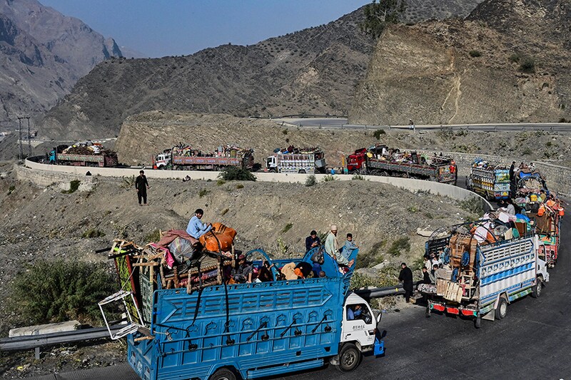 Trucks transporting Afghan refugees with their belongings are seen along a road towards the Pakistan-Afghanistan Torkham border on November 3, 2023, following Pakistan"s government decision to expel people illegally staying in the country. More than 165,000 Afghans have fled Pakistan since Islamabad issued an ultimatum to 1.7 million people a month ago to leave or face arrest and deportation, officials said on November 2.