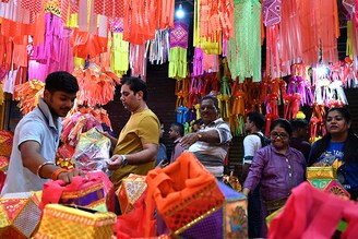 Customers buy colourful paper lanterns and other decorative items at a shop ahead of Diwali, the festival of lights, in Mumbai on November 6, 2023. Diwali will be celebrated on November 12 this year