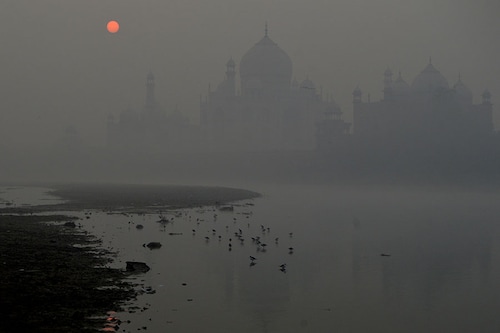 A general view shows the Taj Mahal amid heavy smog conditions as the sun rises in Agra on November 9, 2023.