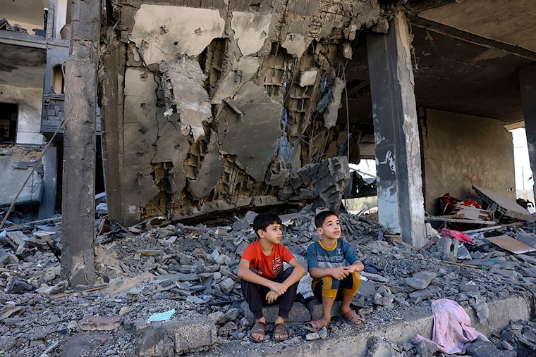 Children sit amid the rubble of a building in the aftermath of an Israeli strike in Rafah in the southern Gaza Strip on November 10, 2023, during ongoing battles between Israel and the Palestinian group Hamas.
