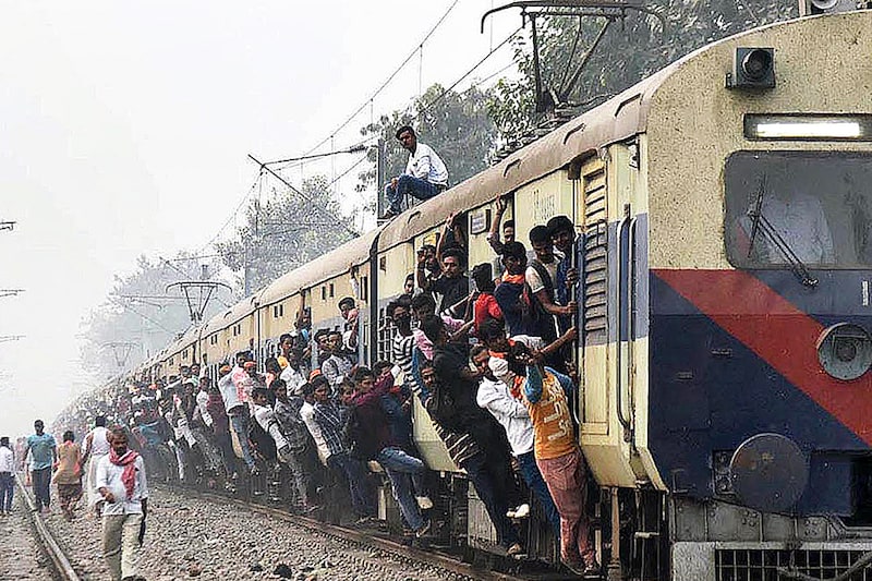 People travel by an overcrowded train to reach their hometowns ahead of the Chhath Puja festival at Patna Junction in Patna, India, on November 16, 2023.