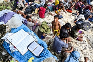 Newly-arrived Rohingya refugees rest on a beach in Sabang island, Aceh province on November 22, 2023.