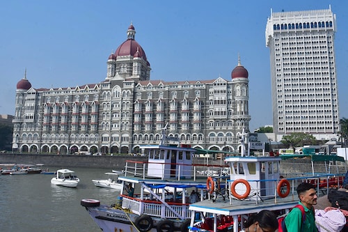 Tourists outside the Taj Mahal Palace hotel, one of the sites of the 26/11, 2008 Mumbai terror attacks, ahead of the anniversary of the gruesome incident, on November 24, 2023 in Mumbai, India. The 2008 Mumbai attacks were a series of terrorist acts that took place in November 2008, when 10 members of Lashkar-e-Taiba, a militant Islamist organisation from Pakistan, carried out 12 coordinated shooting and bombing attacks lasting four days across Mumbai.