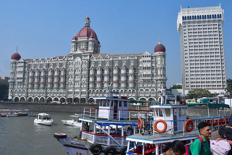 Tourists outside the Taj Mahal Palace hotel, one of the sites of the 26/11, 2008 Mumbai terror attacks, ahead of the anniversary of the gruesome incident, on November 24, 2023 in Mumbai, India. The 2008 Mumbai attacks were a series of terrorist acts that took place in November 2008, when 10 members of Lashkar-e-Taiba, a militant Islamist organisation from Pakistan, carried out 12 coordinated shooting and bombing attacks lasting four days across Mumbai.