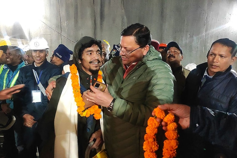 This handout picture released by Uttarakhand"s Department of Information and Public Relations (DIPR) and taken on November 28, 2023, shows a construction worker interacting with Chief Minister of Uttarakhand Pushkar Singh Dhami (R) following his rescue from inside the under-construction Silkyara tunnel during a rescue operation for trapped workers after a section of the tunnel collapsed in the Uttarkashi district of India"s Uttarakhand state. Indian rescuers on November 28 began bringing out the first of the 41 men trapped for 17 days behind tonnes of earth inside a Himalayan road tunnel after a marathon engineering operation to free them.