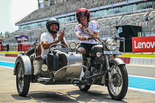 Repsol Honda"s Spanish rider Marc Marquez (R) and India"s former cricket player Suresh Raina ride on a motorbike ahead of the Indian MotoGP Grand Prix at the Buddh International Circuit in Greater Noida on the outskirts of New Delhi, on September 21, 2023. 
Image: Money Sharma / AFP